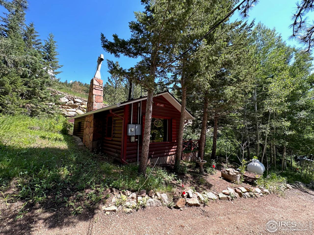 414 Riverside Drive Lyons, CO 80540 - Photo 6 of 23 a view of a wooden bench under a large tree