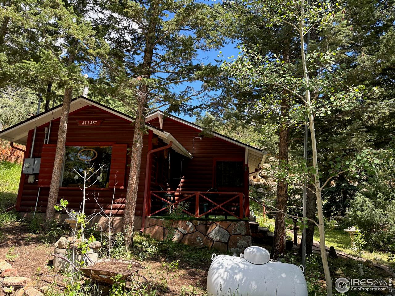 414 Riverside Drive Lyons, CO 80540 - Photo 7 of 23 a front view of a house with patio