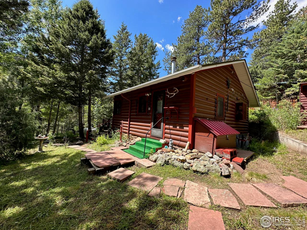 414 Riverside Drive Lyons, CO 80540 - Photo 8 of 23 a backyard of a house with table and chairs
