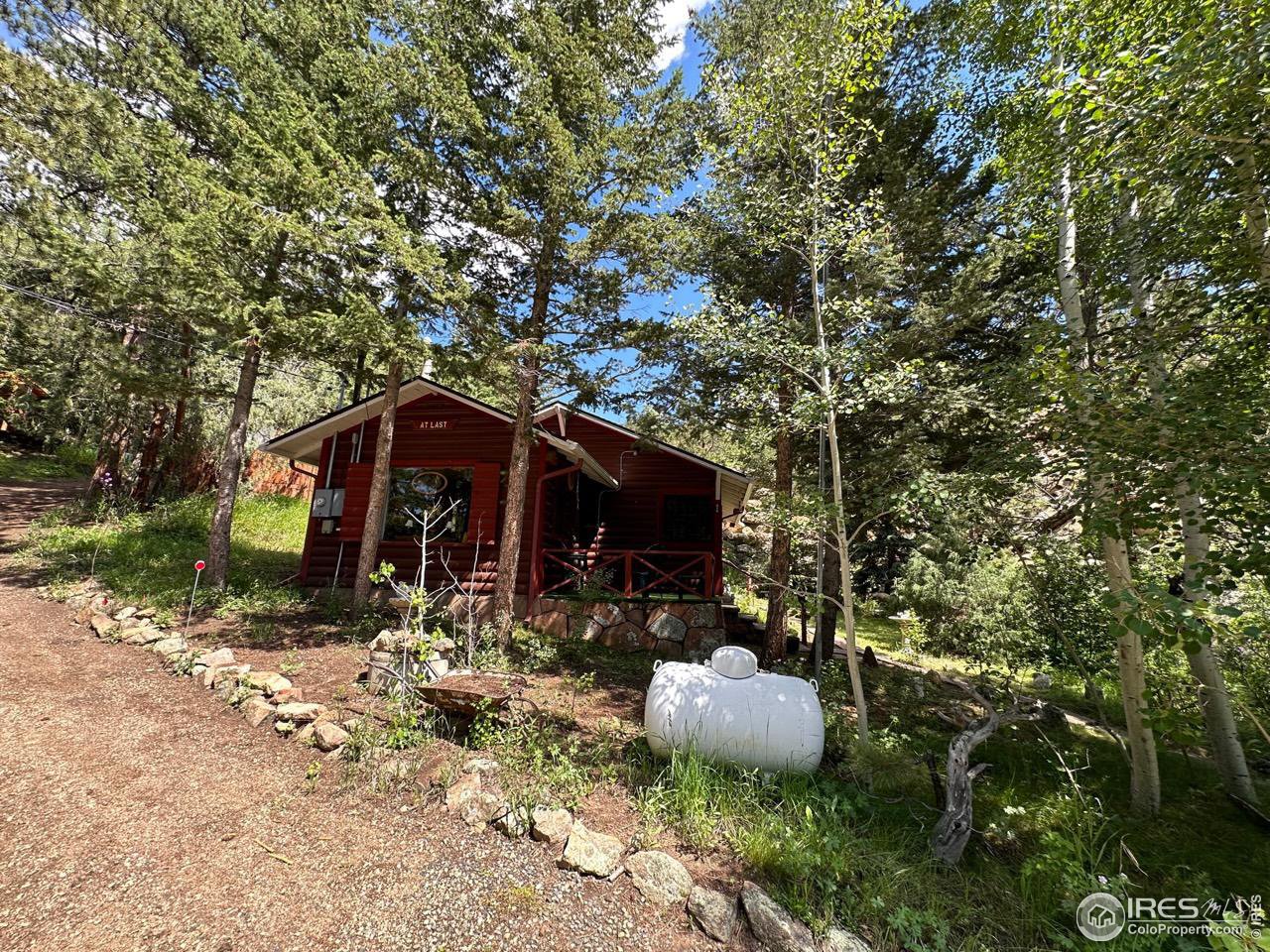 414 Riverside Drive Lyons, CO 80540 - Photo 10 of 23 a view of a wooden house with a yard