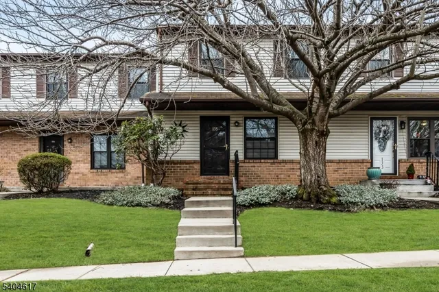 a front view of a house with a yard and outdoor seating