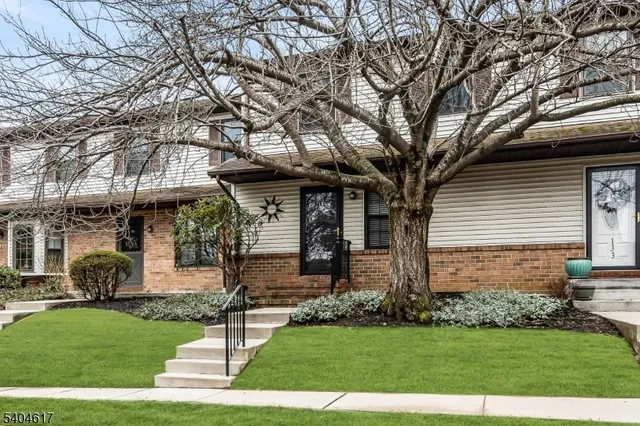 a front view of a house with a garden and yard