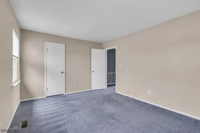 a view of an empty room and wooden floor