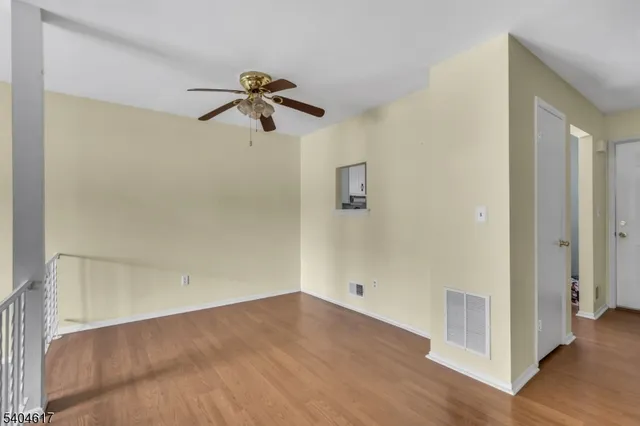 a view of a room with wooden floor
