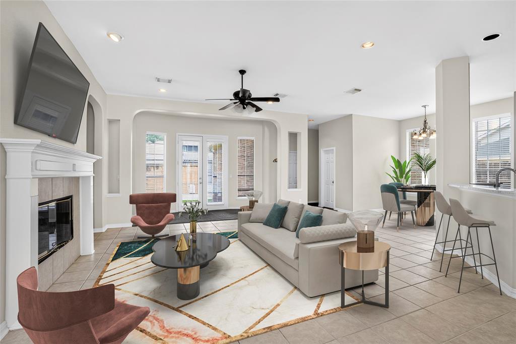 111 Ripplewood Coppell, TX 75019 - Photo 8 of 34 Open-concept living space featuring a fireplace with a white mantel, tile flooring, recessed lighting, and a ceiling fan