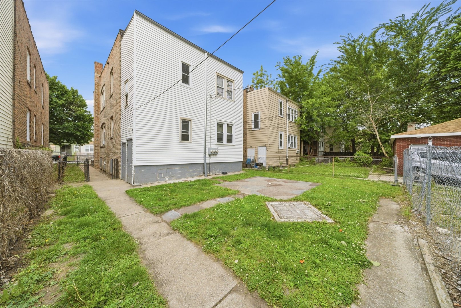 6837 South Morgan Street Chicago, IL 60621 - Photo 19 of 24 a view of a house with a yard
