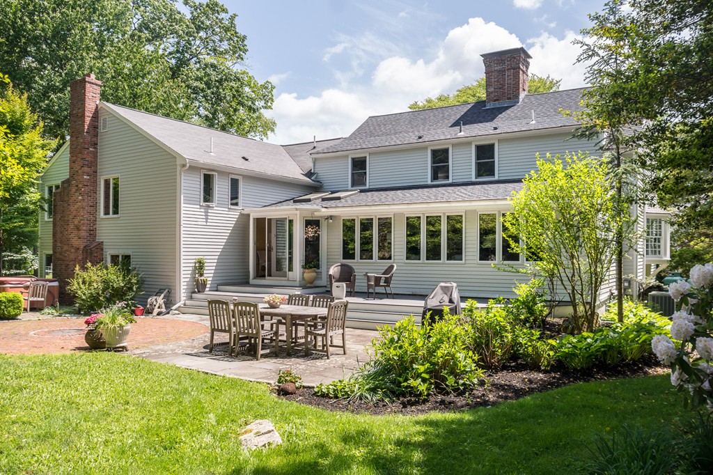 51 Deep Run Cohasset, MA 02025 - Photo 2 of 30 a front view of a house with a yard table and chairs