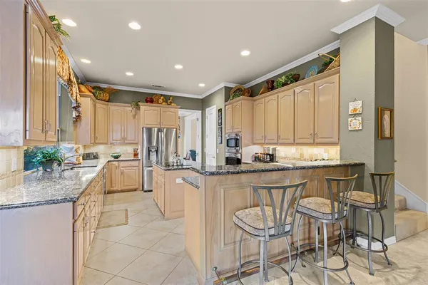 a large kitchen with granite countertop lots of counter top space and dining table