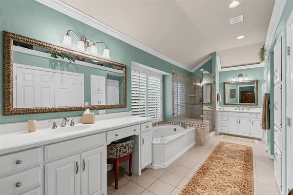 a bathroom with a tub a sink and mirrors