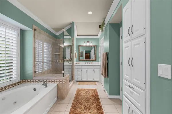 a bathroom with a granite countertop tub shower and sink