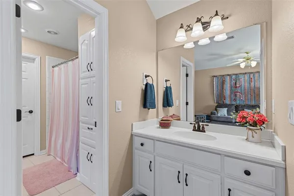 a bathroom with a double vanity sink mirror and shower