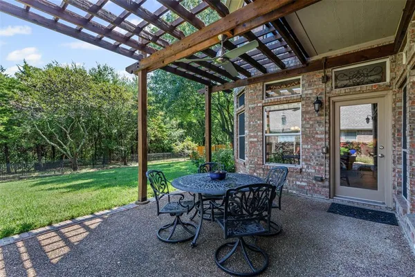 a patio with yard table and chairs