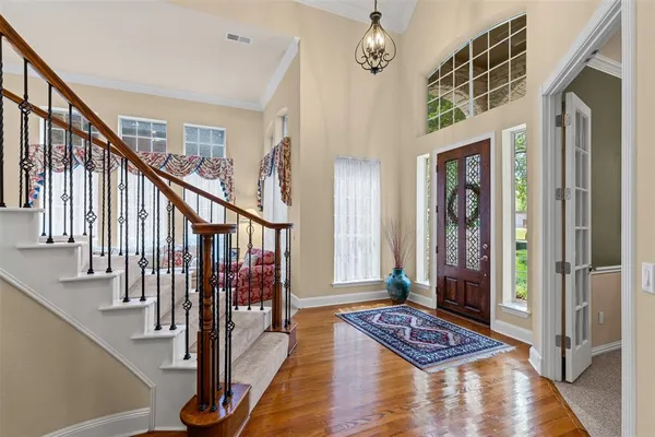 a view of an entryway with wooden floor and stairs