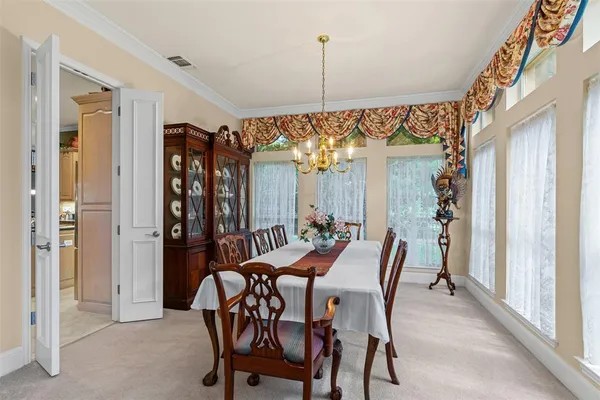 a view of a dining room with furniture and window