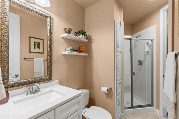 a bathroom with a sink vanity mirror and toilet