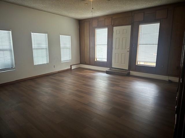 7152 Indian Ridge Trail Dallas, TX 75232 - Photo 17 of 17 an empty room with wooden floor and windows with curtains