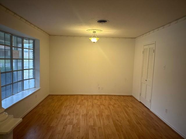 7152 Indian Ridge Trail Dallas, TX 75232 - Photo 2 of 17 wooden floor in an empty room with a window
