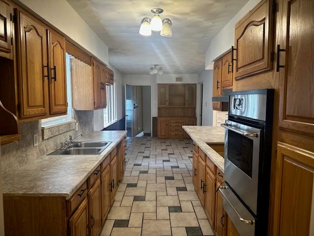 7152 Indian Ridge Trail Dallas, TX 75232 - Photo 5 of 17 a kitchen with granite countertop stainless steel appliances a sink stove and refrigerator