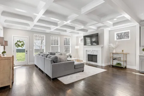a living room with fireplace furniture and a wooden floor