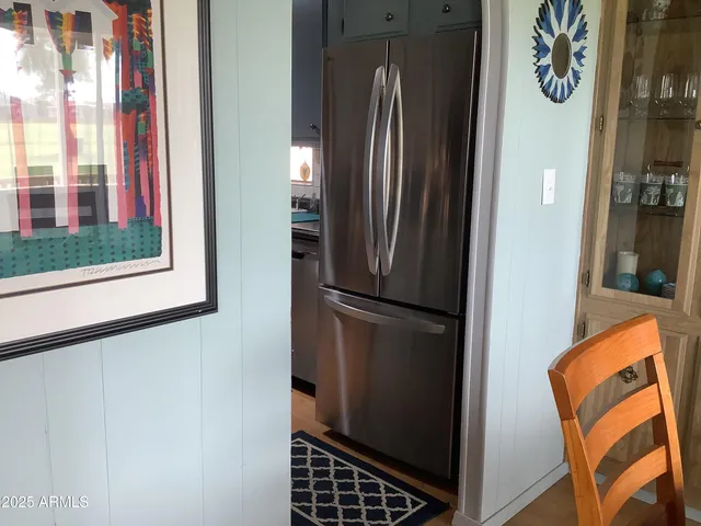 a view of kitchen with furniture and a refrigerator