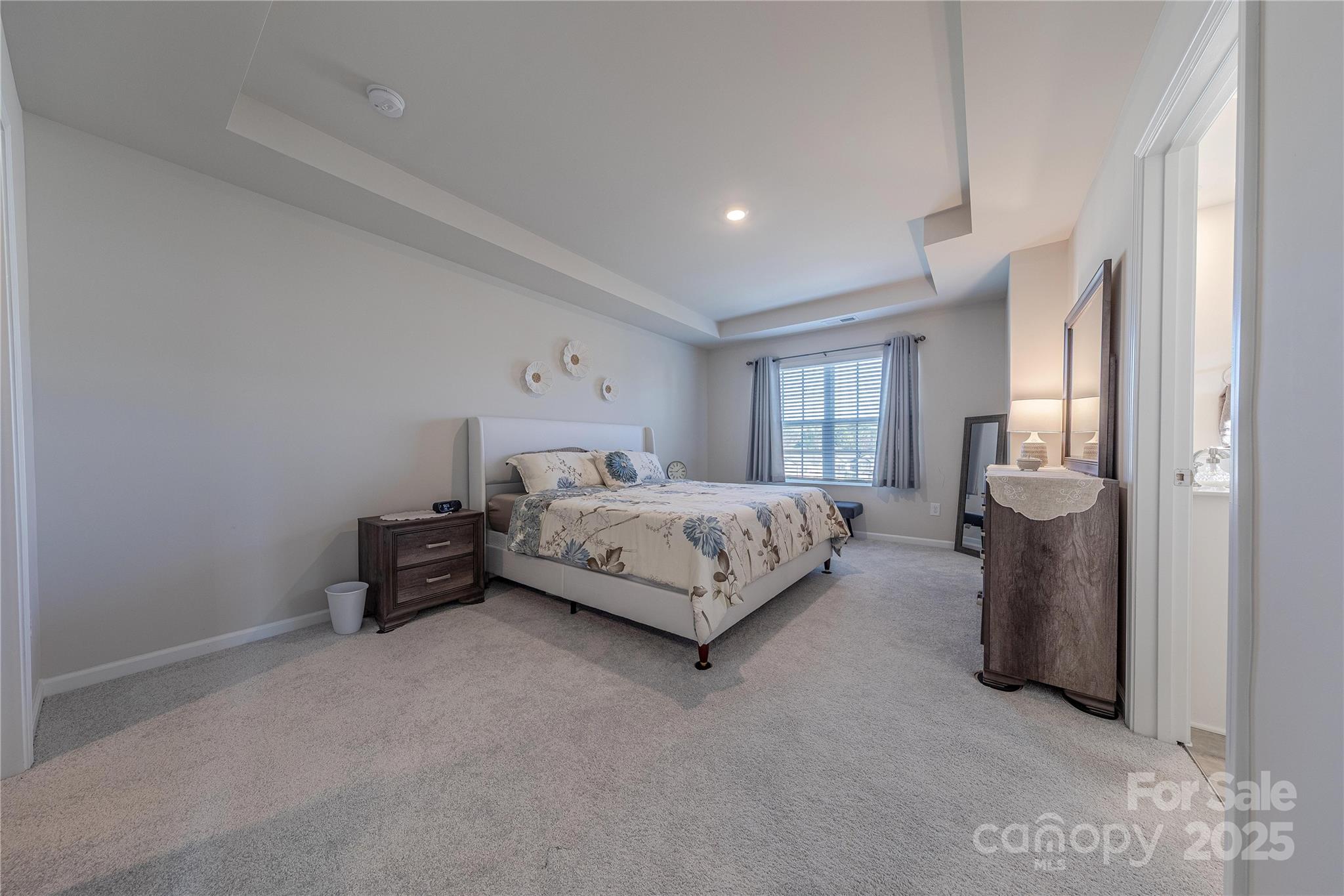 8007 Scarlet Maple Lane Tega Cay, SC 29708 - Photo 13 of 24 a bedroom with a bed and a refrigerator