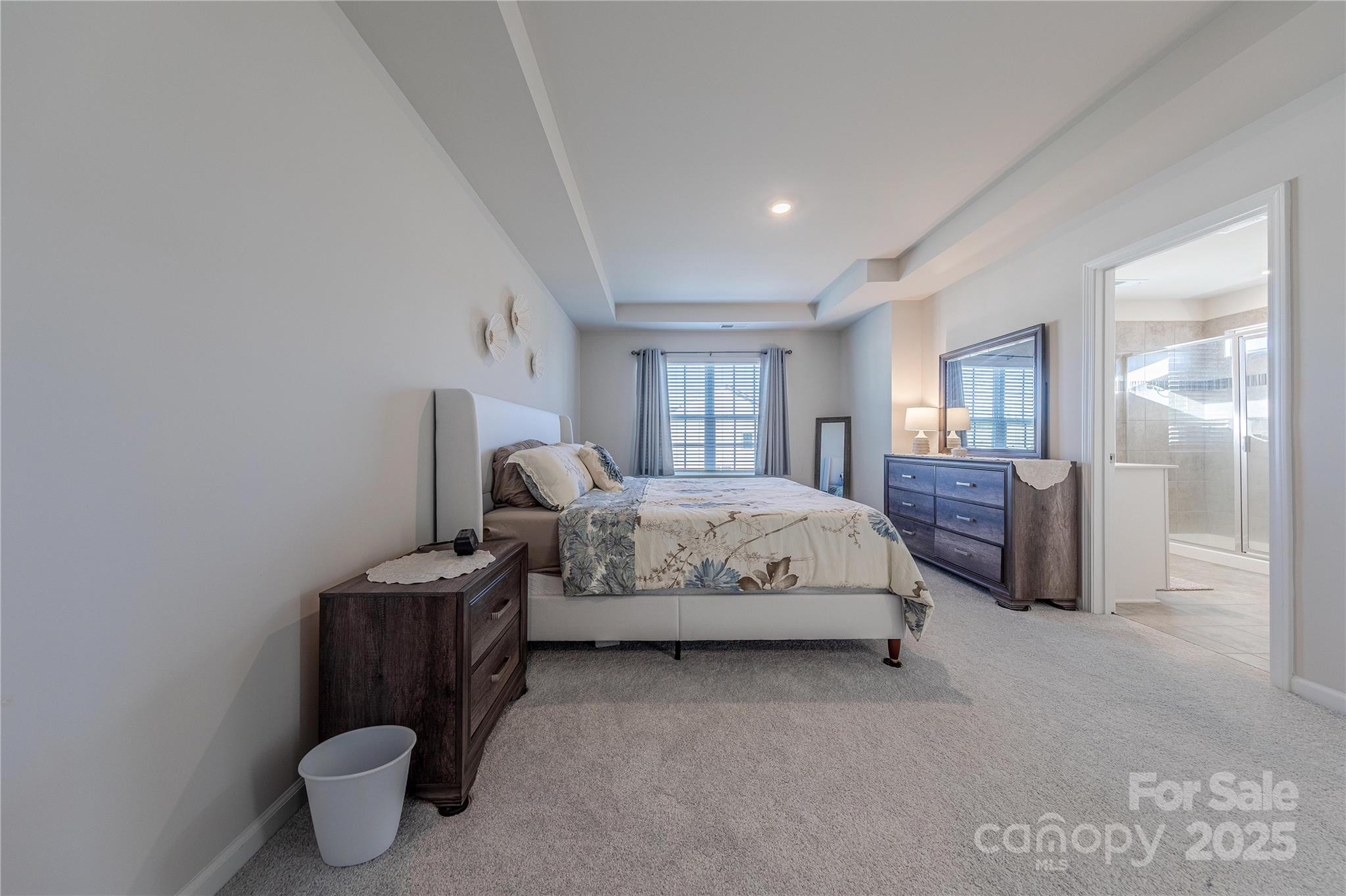 8007 Scarlet Maple Lane Tega Cay, SC 29708 - Photo 14 of 24 a spacious bedroom with a bed and glass door