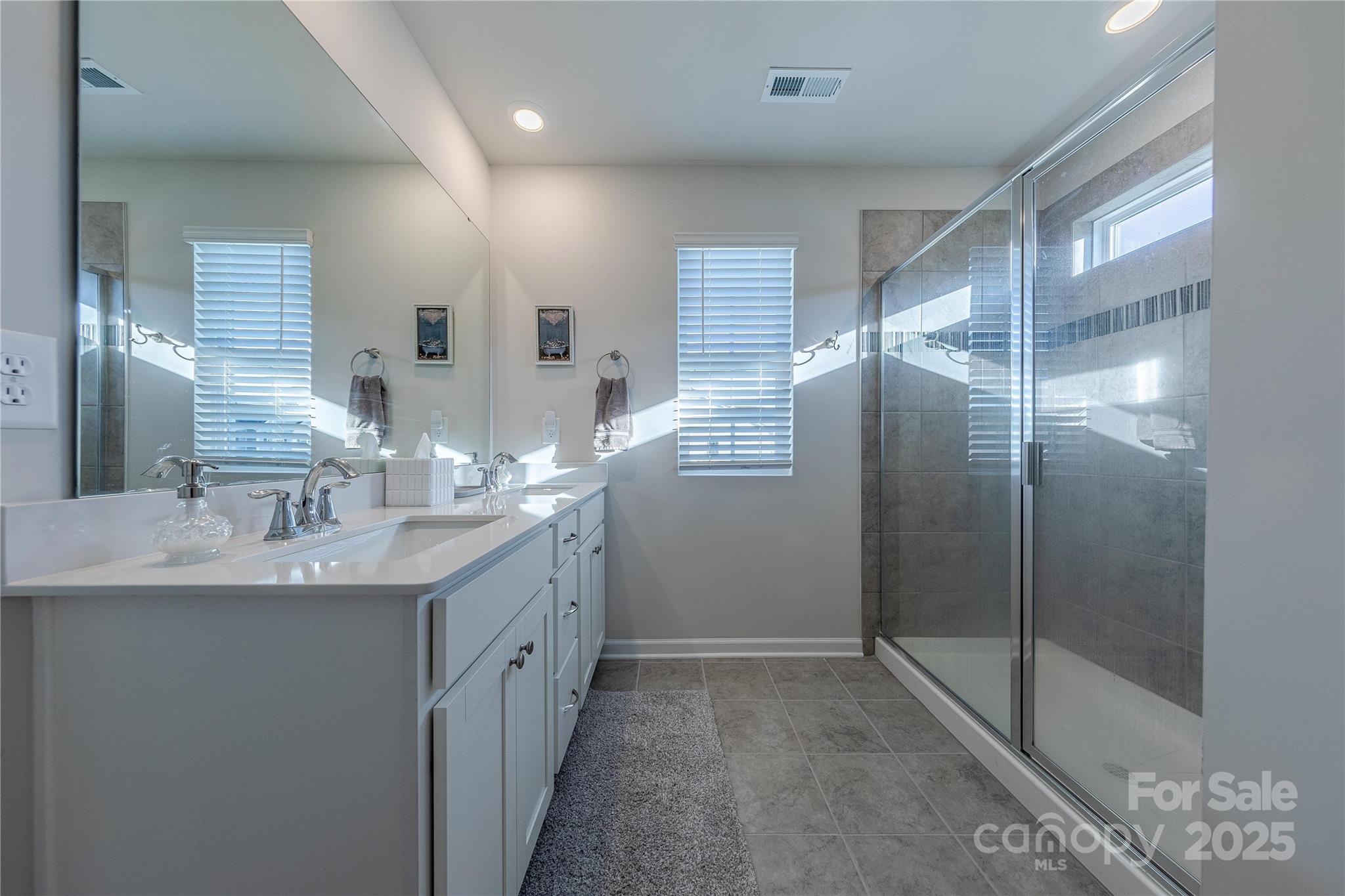 8007 Scarlet Maple Lane Tega Cay, SC 29708 - Photo 15 of 24 a bathroom with a double vanity sink and mirror