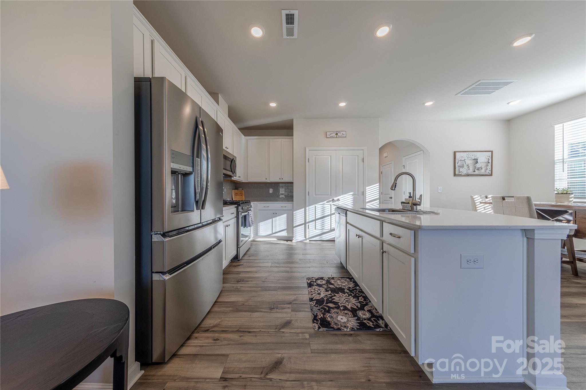 8007 Scarlet Maple Lane Tega Cay, SC 29708 - Photo 6 of 24 a kitchen with white cabinets and appliances