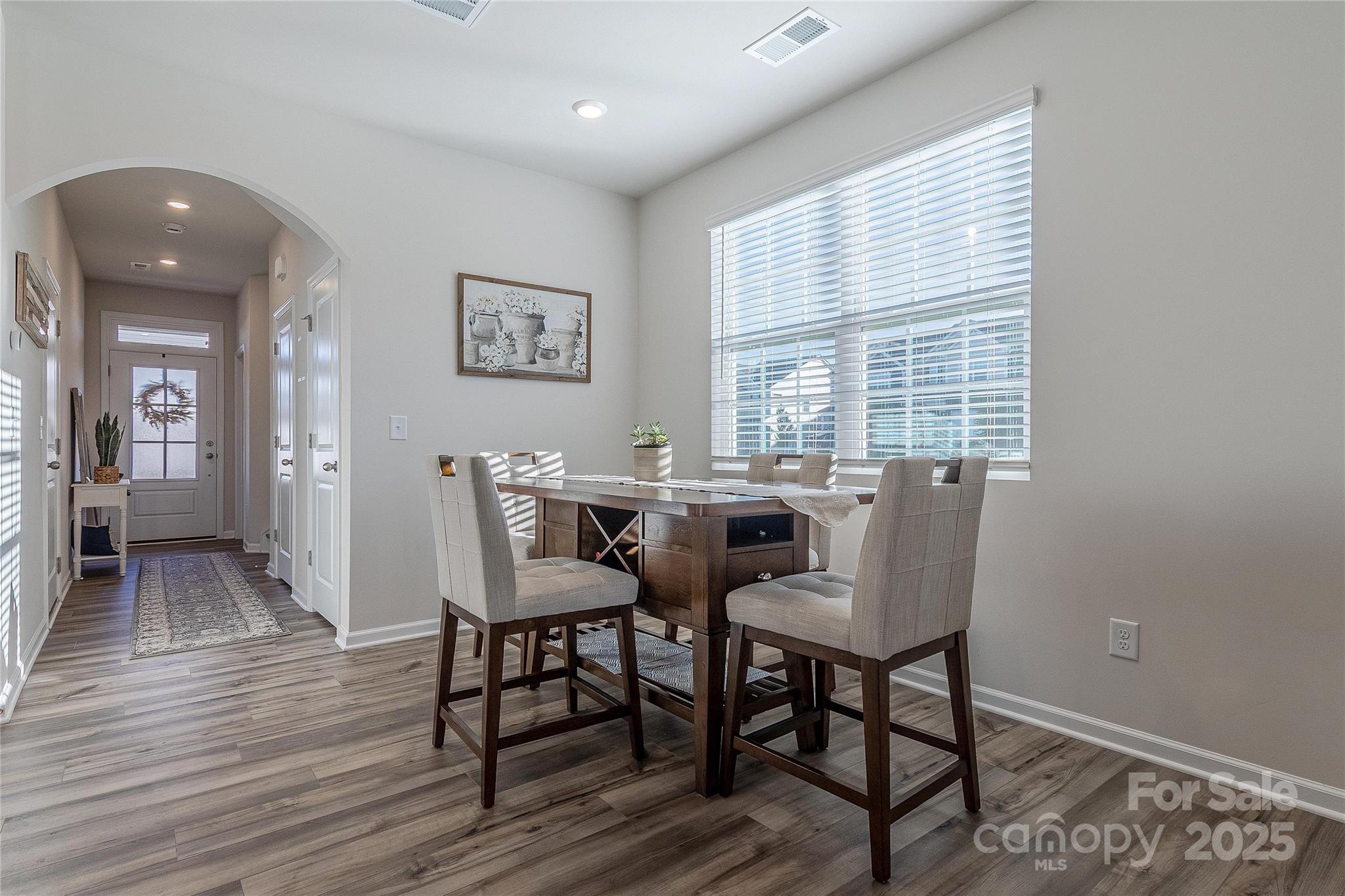 8007 Scarlet Maple Lane Tega Cay, SC 29708 - Photo 10 of 24 a view of a dining room with furniture and wooden floor