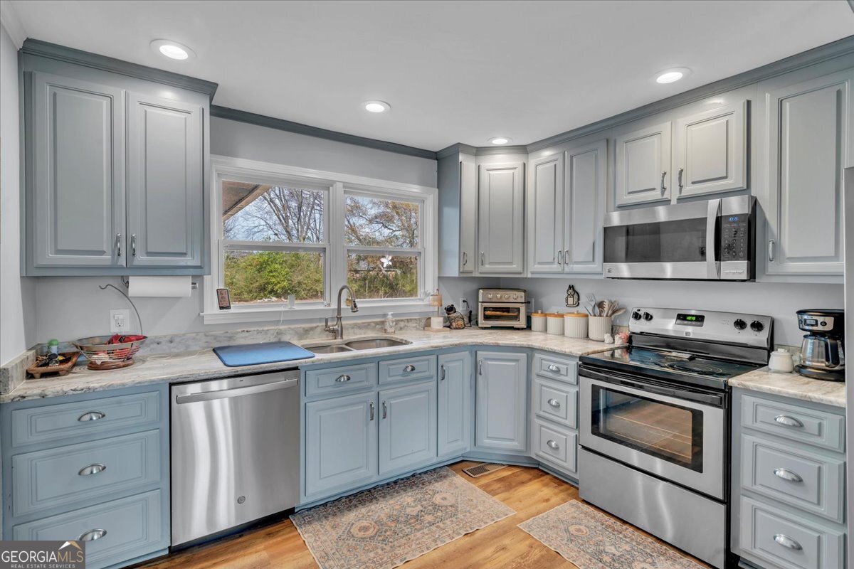 480 Country Club Road Dublin, GA 31021 - Photo 11 of 42 a kitchen with stainless steel appliances granite countertop a stove a sink and a microwave