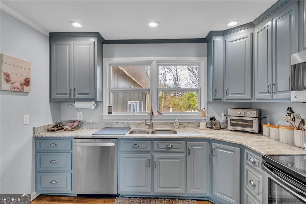 480 Country Club Road Dublin, GA 31021 - Photo 14 of 42 a kitchen with stainless steel appliances granite countertop a sink window and cabinets