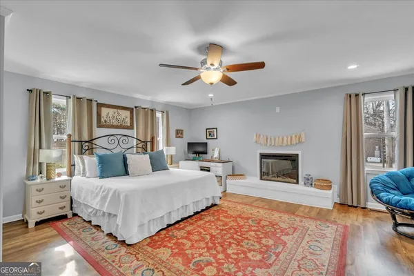 a bedroom with a large bed and a fireplace