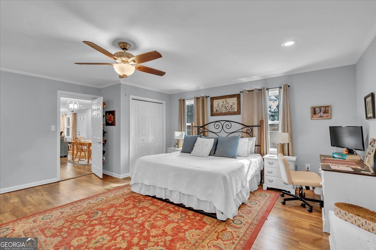 480 Country Club Road Dublin, GA 31021 - Photo 20 of 42 a bedroom with a bed and a chandelier