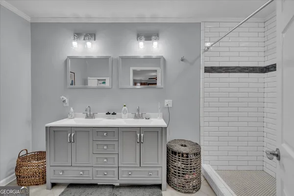 a bathroom with a sink double vanity and tub