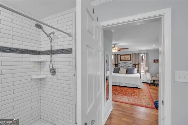 a view of a walk in closet and bathroom