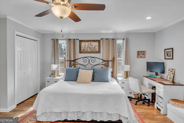 a bedroom with a bed and wooden floor