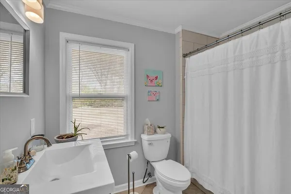 a bathroom with a sink a toilet and a tub