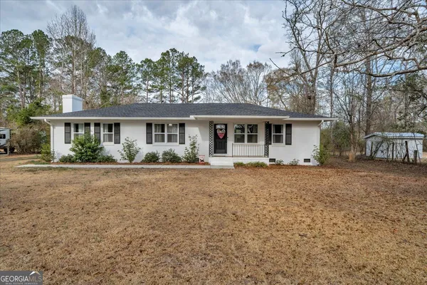 a front view of a house with a garden