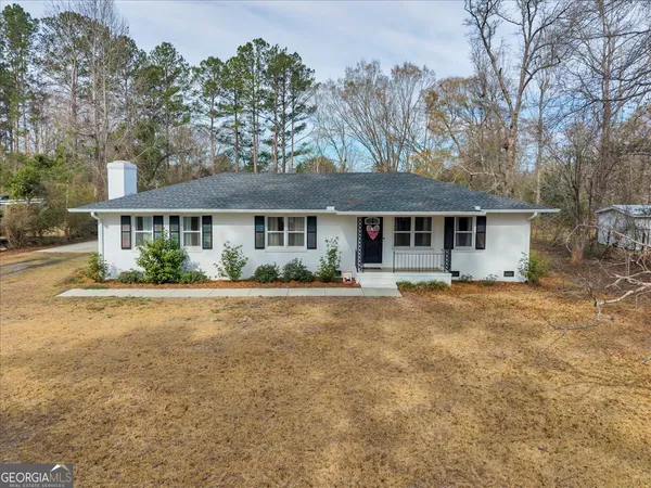a front view of a house with a garden