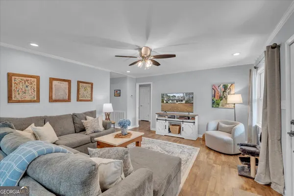 a living room with furniture and a flat screen tv