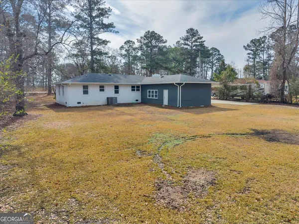 a front view of house with yard and trees