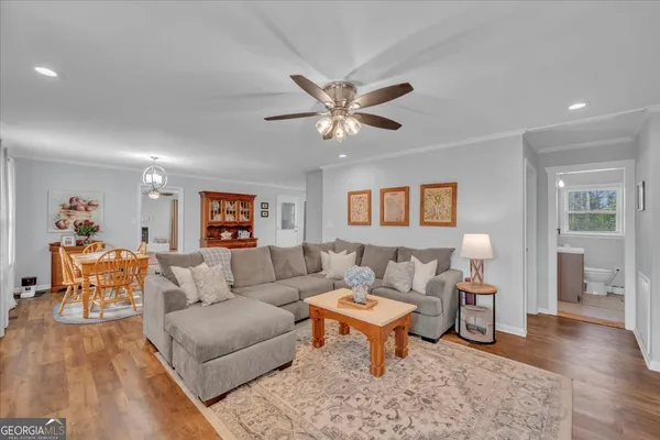 a living room with furniture and a wooden floor