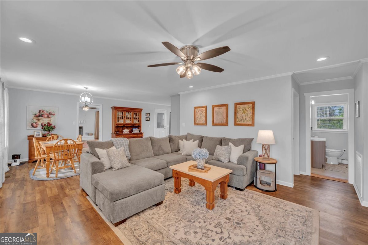 480 Country Club Road Dublin, GA 31021 - Photo 7 of 42 a living room with furniture and a wooden floor