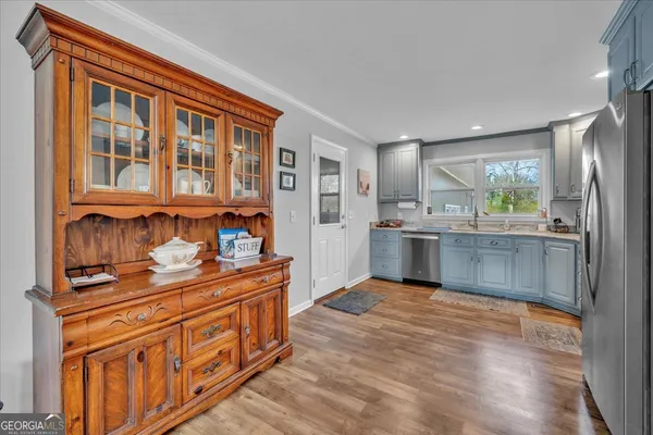 a kitchen with stainless steel appliances granite countertop a stove and cabinets