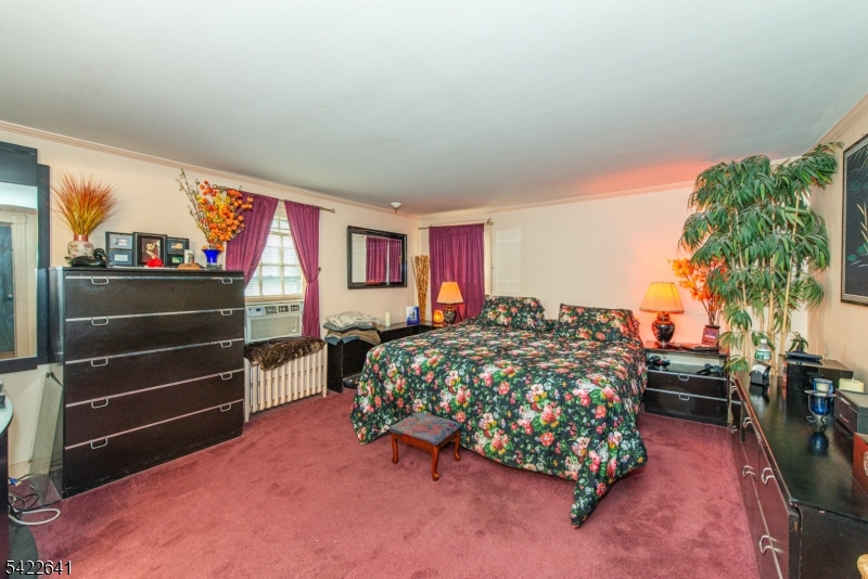 570 Mine Brook Road Bernardsville, NJ 07924 - Photo 19 of 38 a bed sitting in a bedroom next to a window