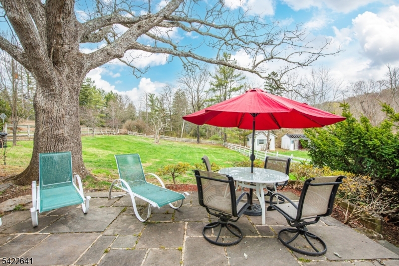 570 Mine Brook Road Bernardsville, NJ 07924 - Photo 26 of 38 a view of a backyard with sitting area and a garden
