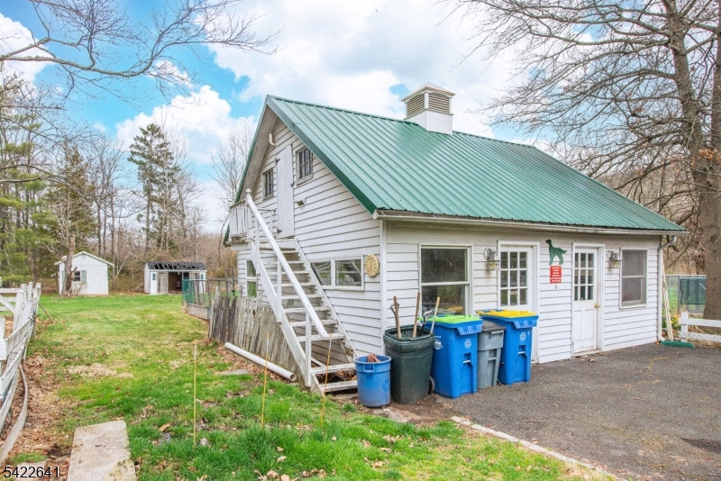 570 Mine Brook Road Bernardsville, NJ 07924 - Photo 28 of 38 a view of a house with a yard and chairs