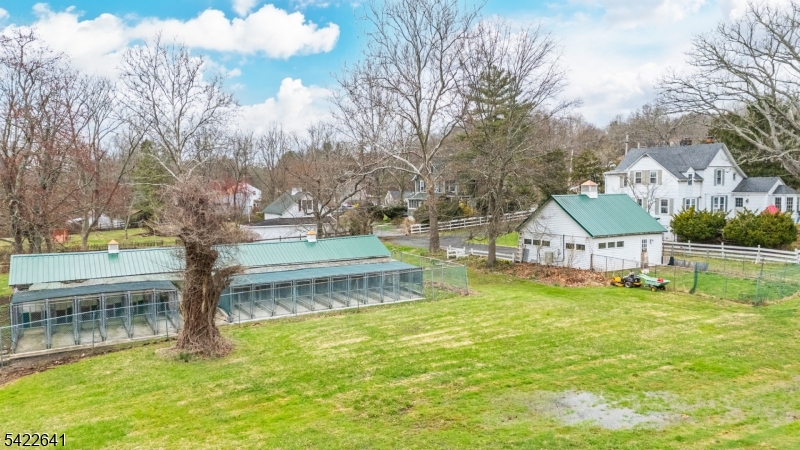570 Mine Brook Road Bernardsville, NJ 07924 - Photo 33 of 38 a white house with a big yard and large trees