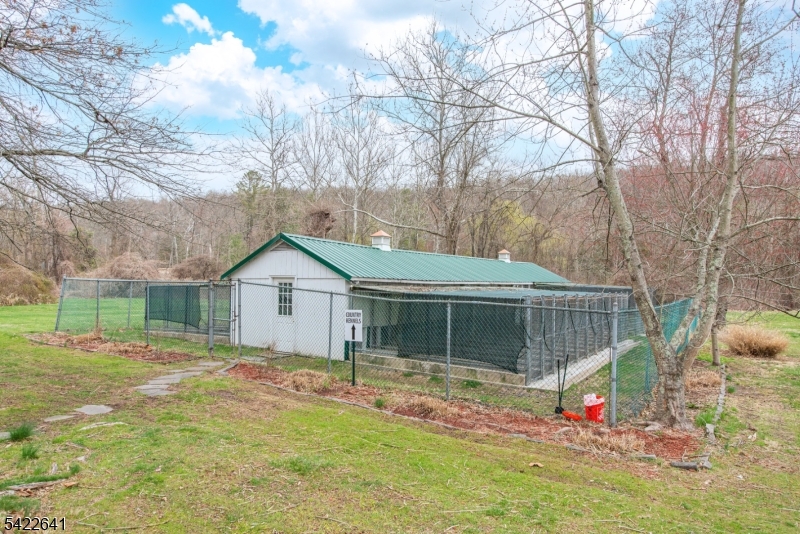 570 Mine Brook Road Bernardsville, NJ 07924 - Photo 35 of 38 a view of a house with a yard and large tree