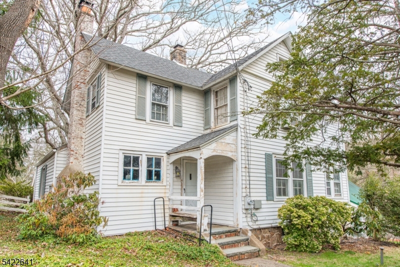 570 Mine Brook Road Bernardsville, NJ 07924 - Photo 5 of 38 a front view of a house with garden